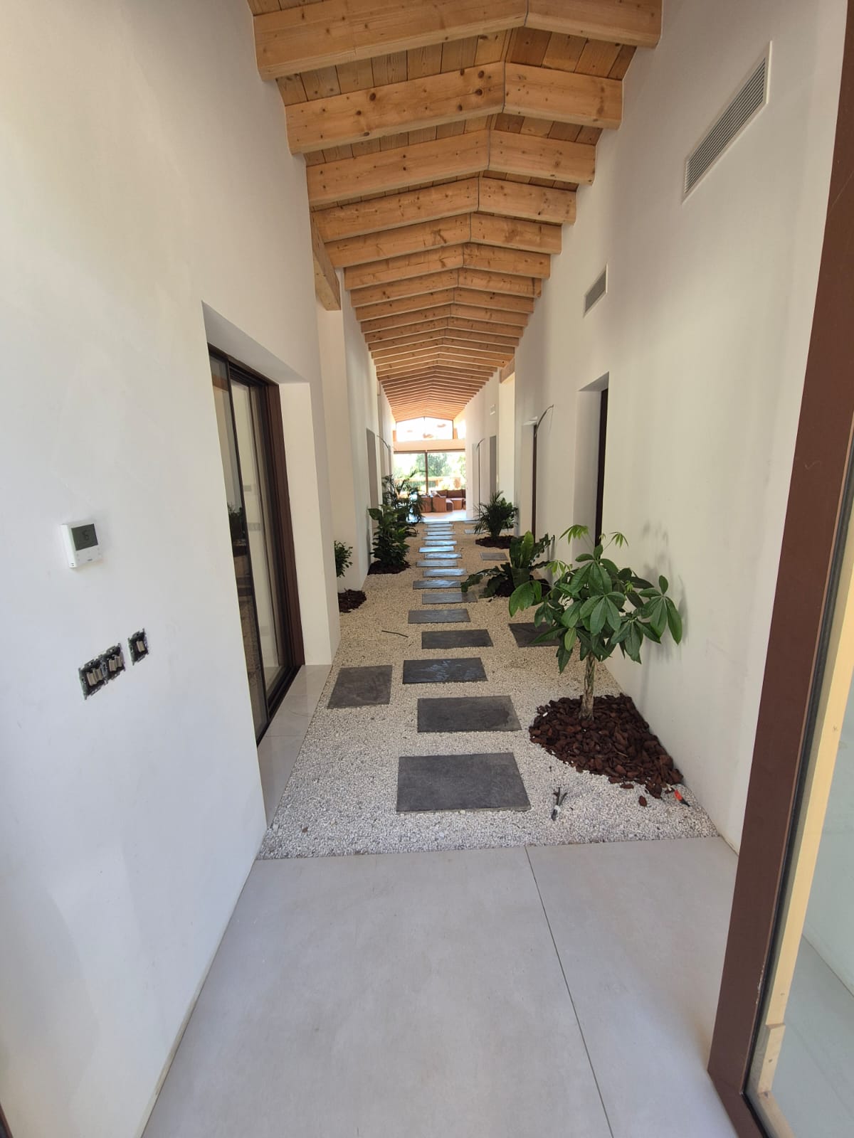 Couloir avec carrelage et plafond bois
